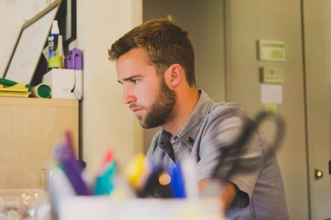 A man looking at his laptop