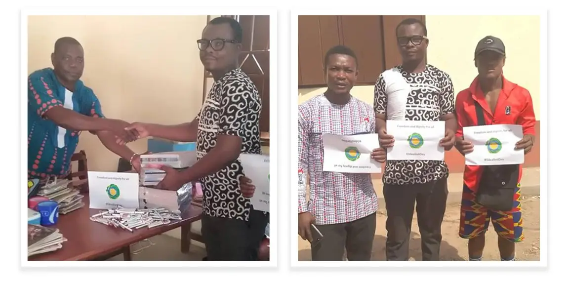 Francis Osei posing with other volunteers holding up a print out of the Idealist logo.