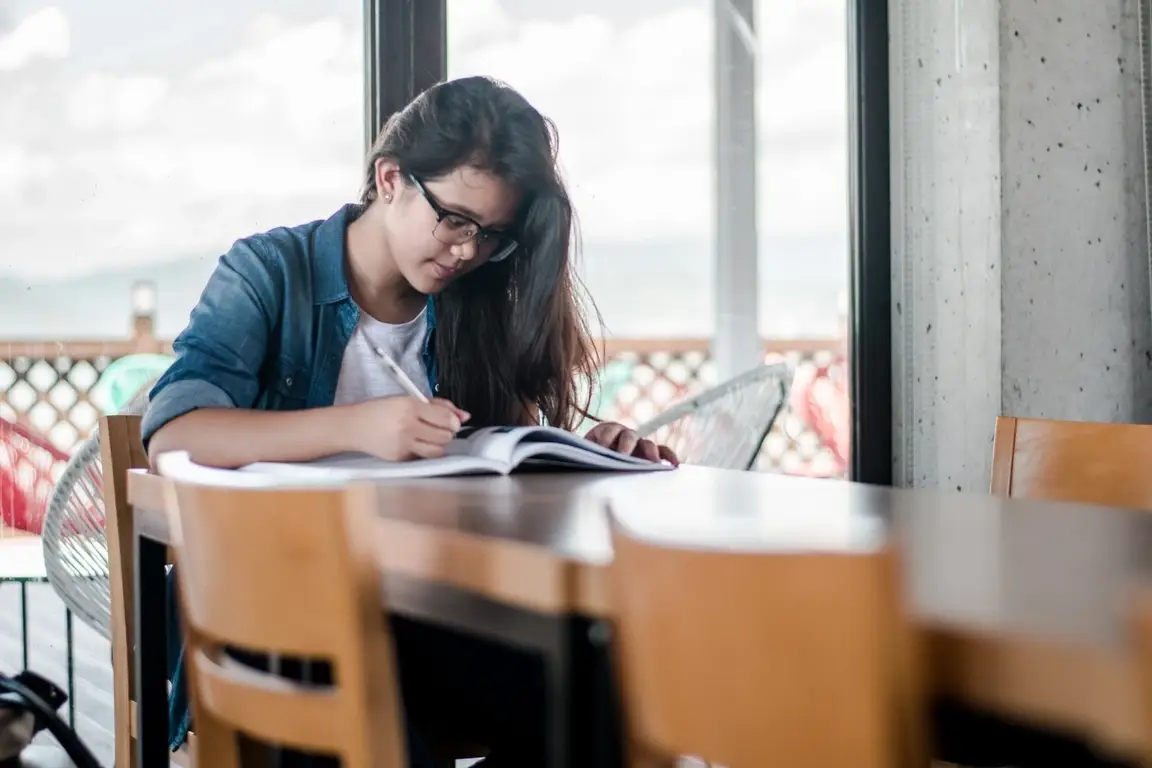 A woman studying at a table.