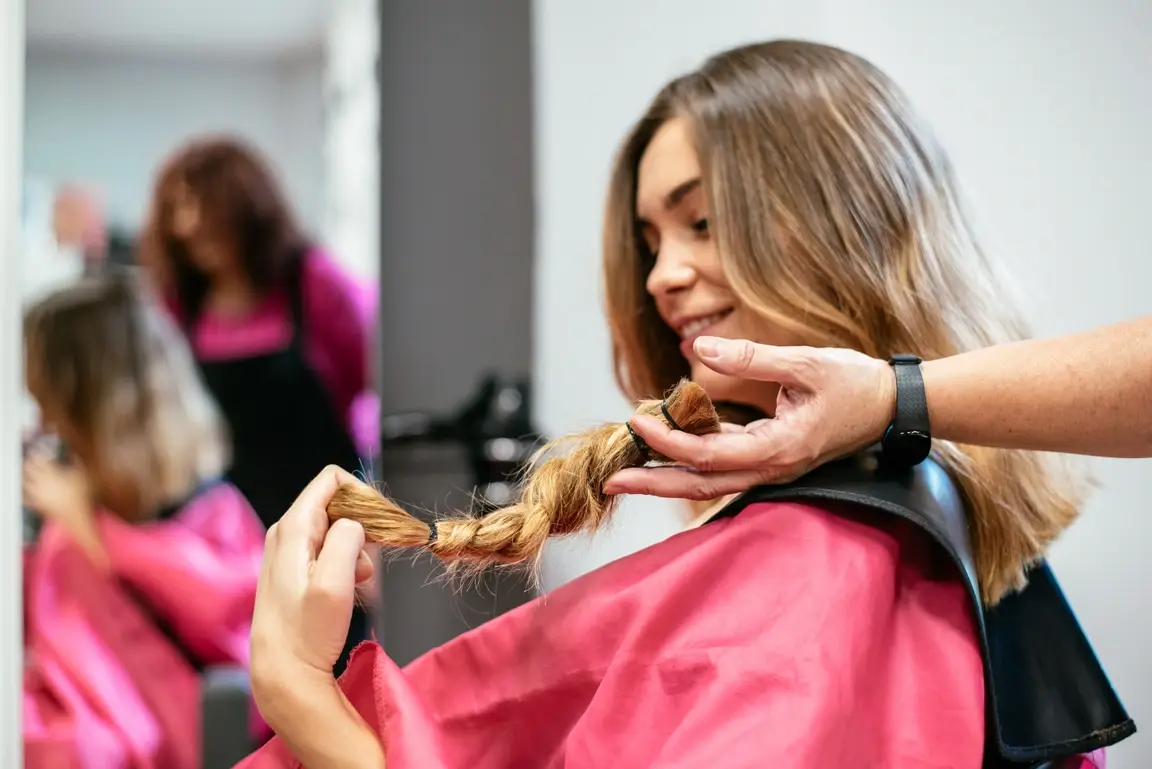 Woman examining newly-cut hair.