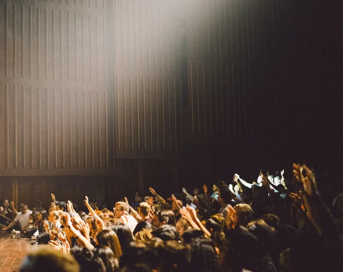 A group of people with their arms raised.