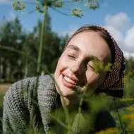 woman laying in tall grass