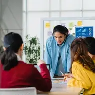 Group of young creatives discuss business.