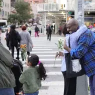 two people hugging after exchanging flowers