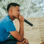 young person speaking into a microphone