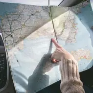 Someone points at a map.