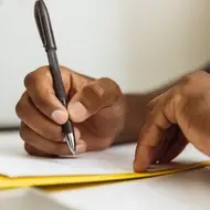 Close-up of hand writing a letter