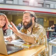 woman and man working together at laptop