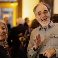 Docent smiling and waving with patron