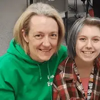 Mother and daughter at tax prep site smiling