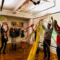 Group throwing colored ribbons into the air