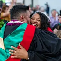 Divinity students hugging at graduation