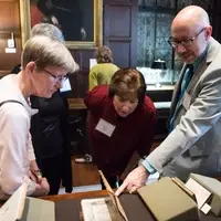 Director of Collections/Eric Weinmann Librarian showing patrons exhibits