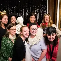 Folger Development team taking a photo booth picture with a william shakespeare bust and other props at donor event