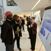 Student and Faculty presenting a research poster