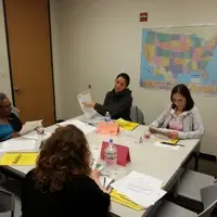 four women at a table, sharing about their home countries