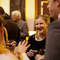 woman staff member smiling in group at Folger event