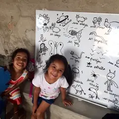 Two kids near a whiteboard after the activity