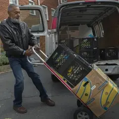 volunteer delivering food on dolly