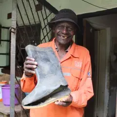 Saulus holding an old broken rain boot