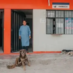 The psychologist is standing near the door of the local clinic