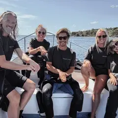 Interns on the boat giving the turtle sign