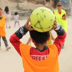 A child holding a football ball