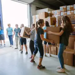 Young women loading a shipping container