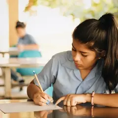 Middle School student writing in the cafeteria