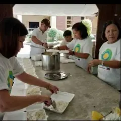 A group of Idealists work on a kitchen project together.