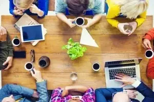 An overhead shot of a meeting at a cafe.