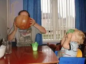A man and child drinking out a bowl.
