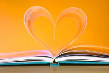 An open book with two pages forming a heart.