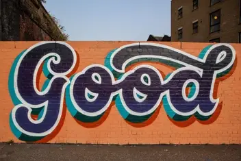 The word good painted on a wall.