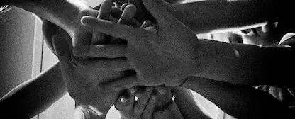 A group of hands in a huddle.