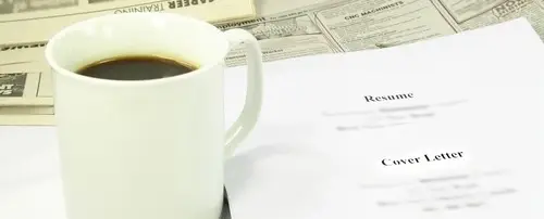 A resume. Next to it is a cup of coffee.