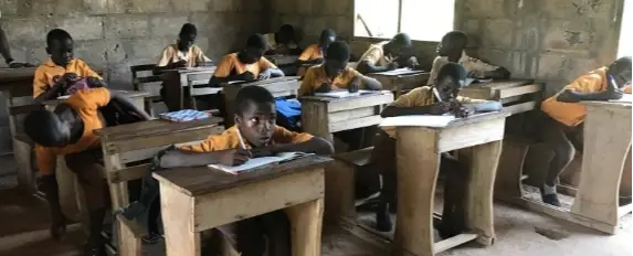 A group of children learning in a classroom.