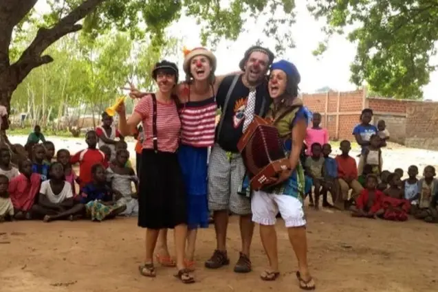 A group of clowns perform for children.