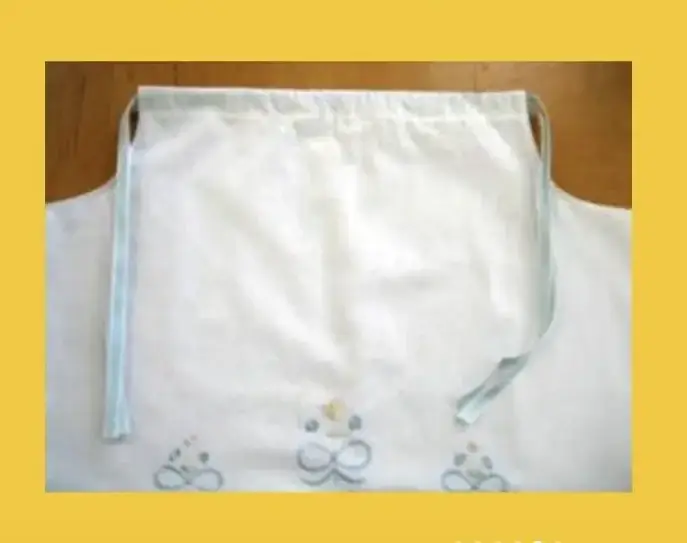 An image showing a pillowcase dress with additional embroidery or appliqués sewn on for decoration. A pocket is being added to the dress using a template from Sew Daily.