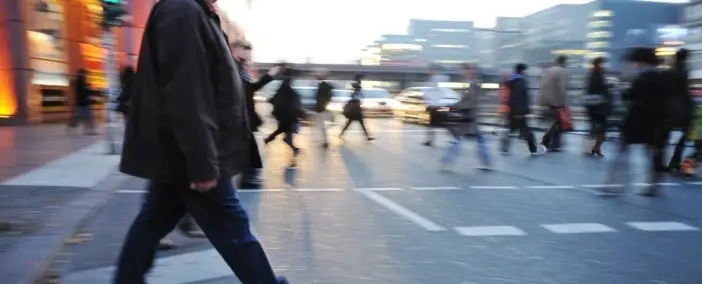 A busy street with many people walking by.