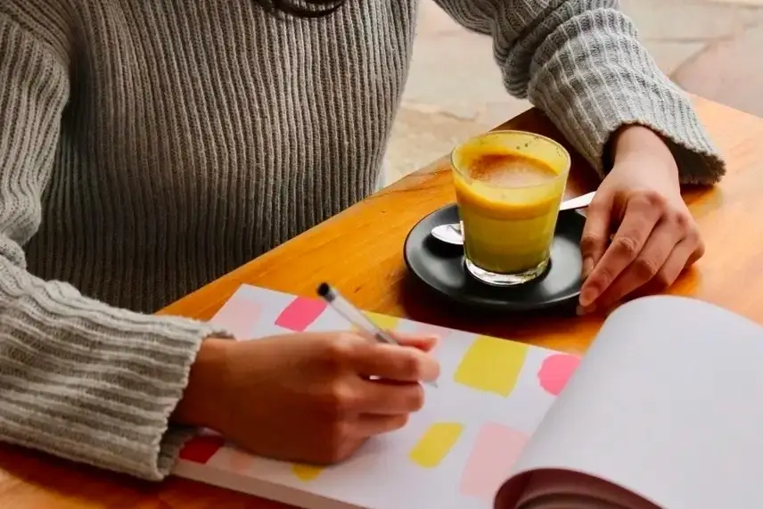 Mulher escrevendo em um caderno