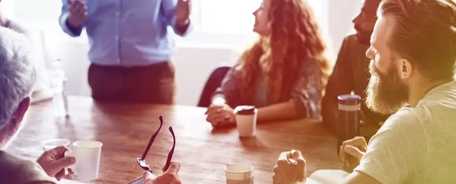 A group of people in a conference room working.