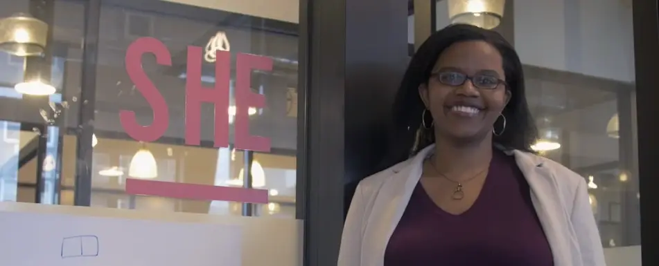 Connie Lewin smiles next to her office.