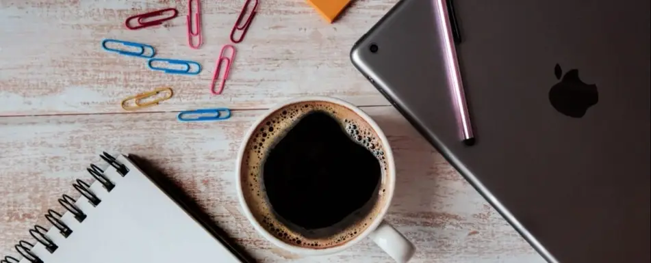 A cup of coffee on a work desk.