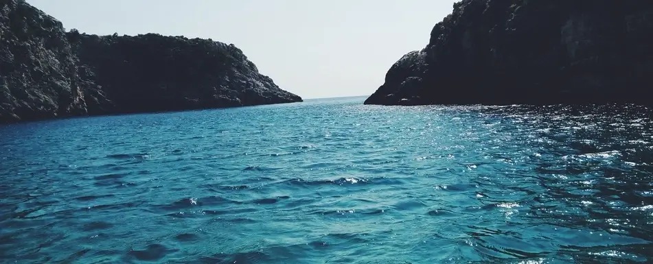 The ocean and two mountains.