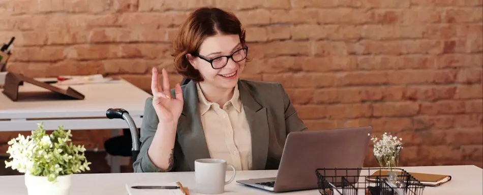 Woman smiling and waving during video interview