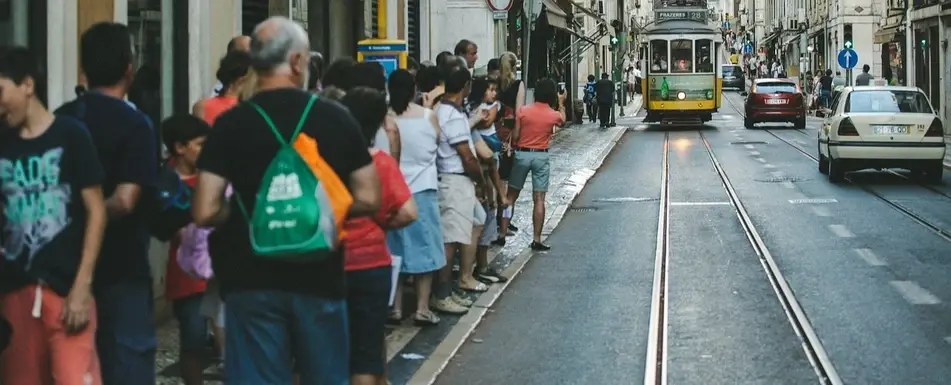 A crowd of people waiting for the bus.