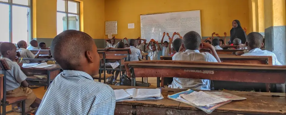 children having a lesson in a run-down school