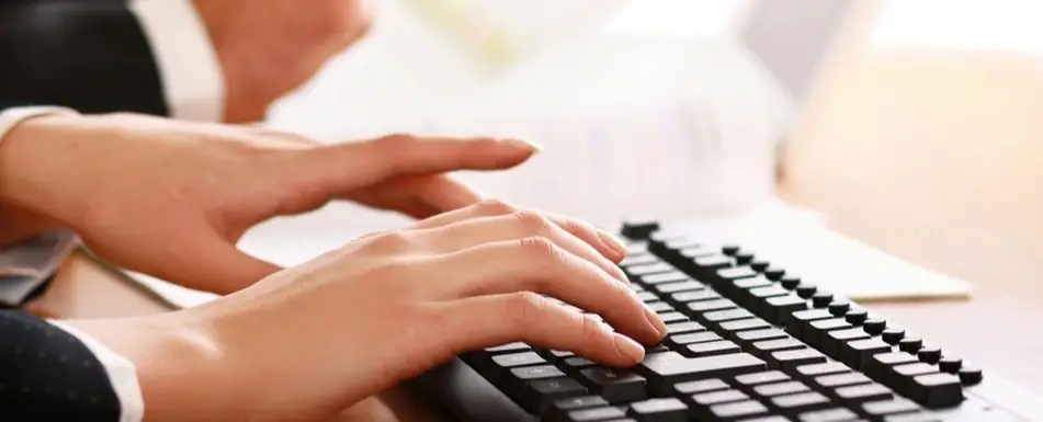 A person typing on a keyboard.