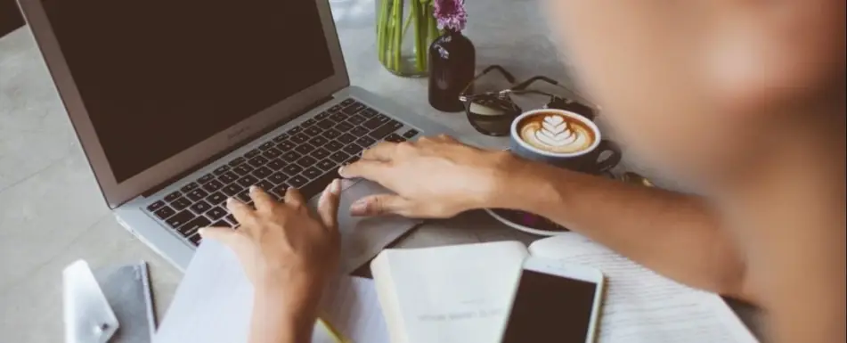 Someone typing on a laptop.